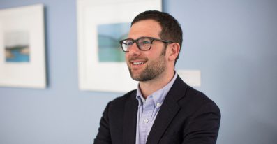 A male Services Support staff member in an office environment.