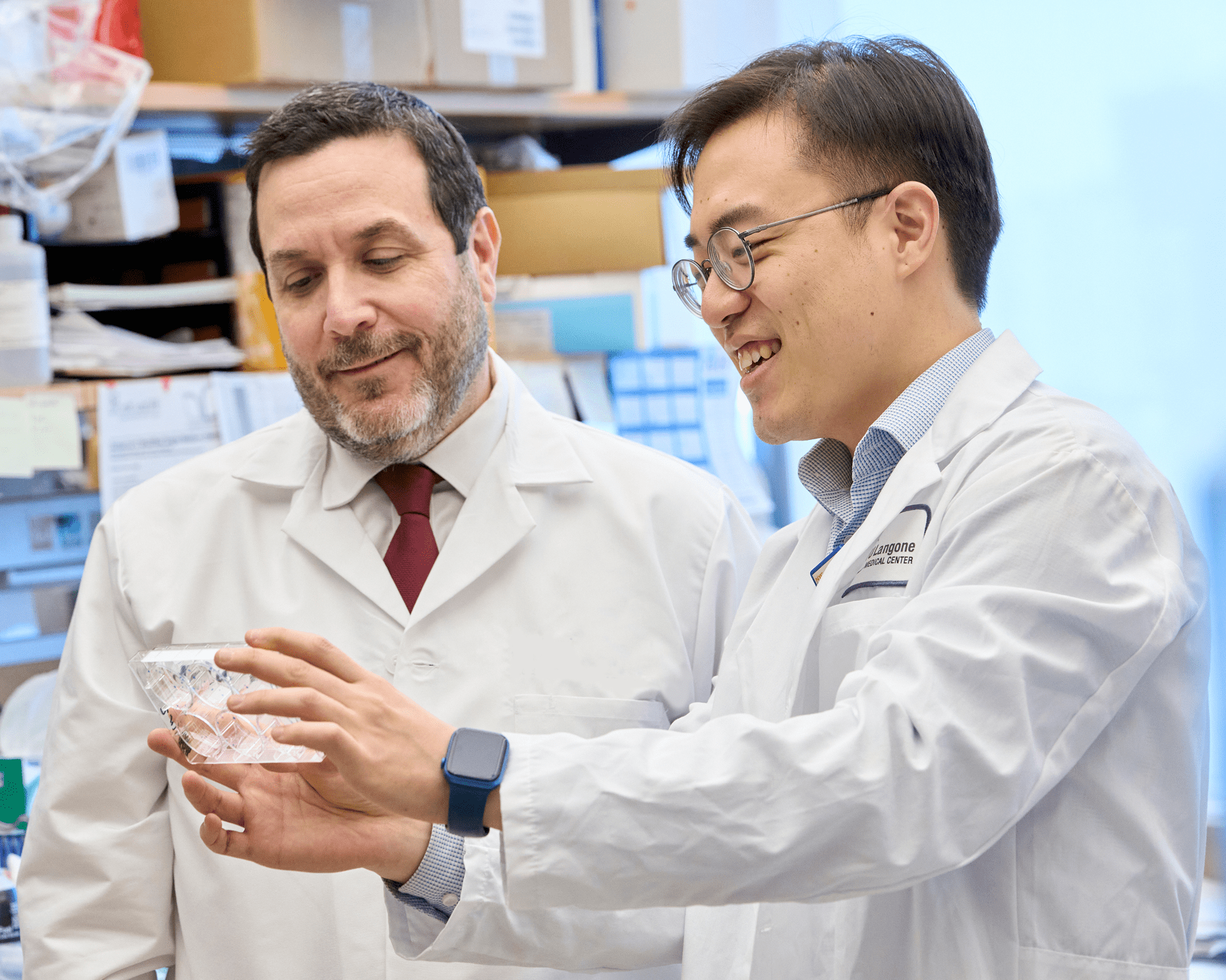 Two laboratory staff at NYU Langone look at a laboratory specimen.