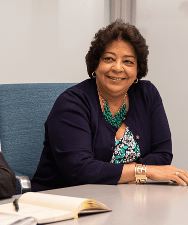 Three members of NYU Langone’s leadership team sit at a desk, working together.